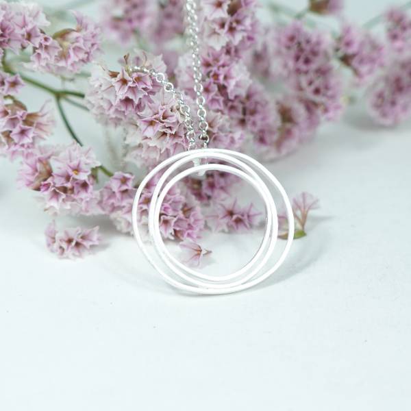Round matte silver pendant in Barcelona