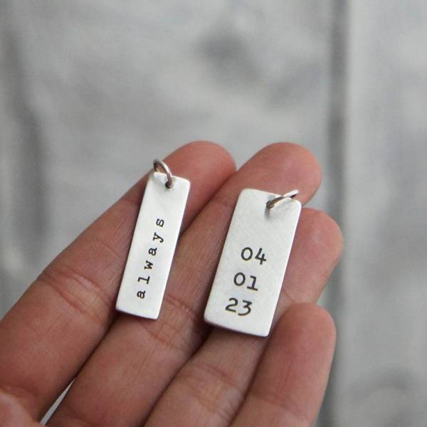 Narrow rectangular pendant type plate in sterling silver with a matt finish.