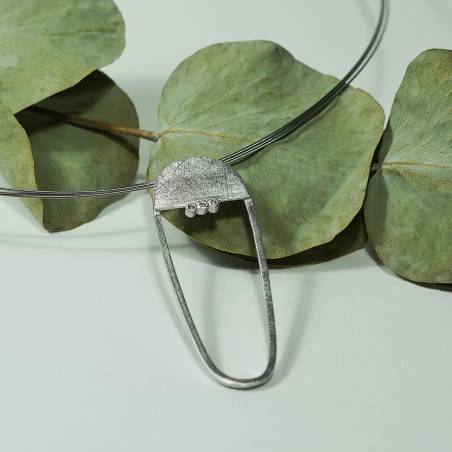 Sterling silver pendant with a rhodium finish and three natural diamonds