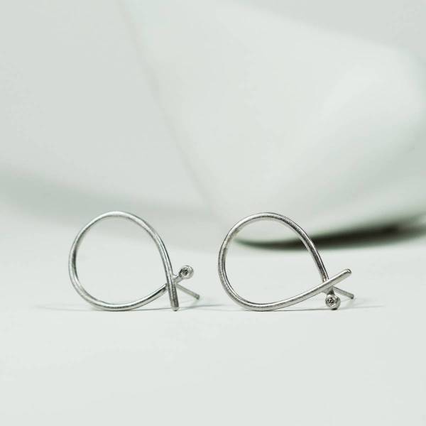Romantic design earrings made of rhodium silver with genuine diamonds