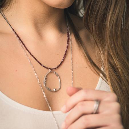 Sterling silver pendant with rhodium diamond matte finish. It has a pink tourmaline