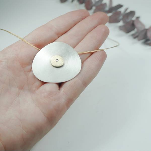In Barcelona, big silver and gold pendant with diamond